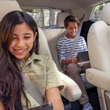 2022 Buick Enclave showing two children happily seated in back seats