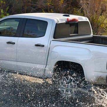 2022 GMC Canyon driving through stream