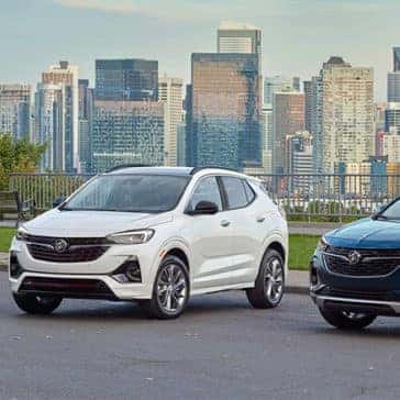 3 2023 Buick Encore vehicles parked in front of cityscape