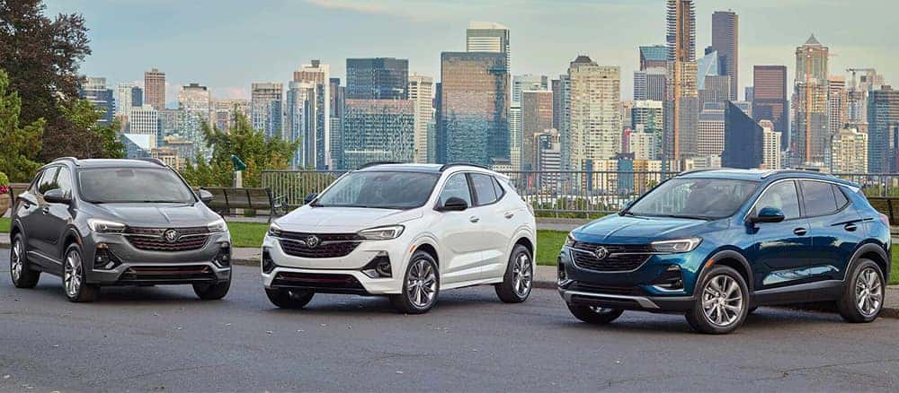 3 2023 Buick Encore vehicles parked in front of cityscape