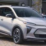 Family walking toward the 2023 Chevy Bolt EUV in Silver Flare Metallic