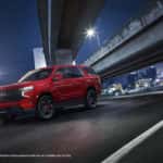Front motion shot of the 2023 Chevrolet Tahoe RST Performance Edition with city backdrop.
