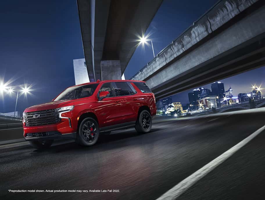 Front motion shot of the 2023 Chevrolet Tahoe RST Performance Edition with city backdrop.