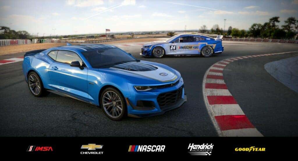 Front 3/4 view of the 2024 Chevrolet Camaro ZL1 Garage 56 Edition driving alongside Garage 56 Chevrolet Camaro ZL1 race car. Pre-production model shown. Actual production model may vary. Available later this year as a 2024 model. Closed Course.
