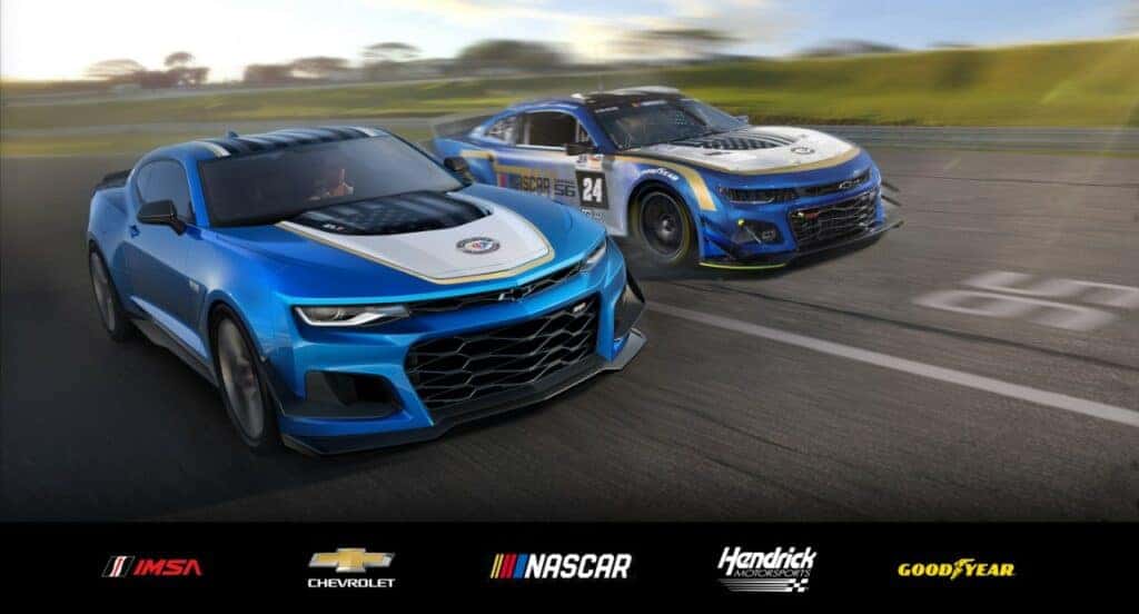 Front 3/4 view of the 2024 Chevrolet Camaro ZL1 Garage 56 Edition on track with the Garage 56 Chevrolet Camaro ZL1 race car in the background. Pre-production model shown. Actual production model may vary. Available later this year as a 2024 model. Closed Course.