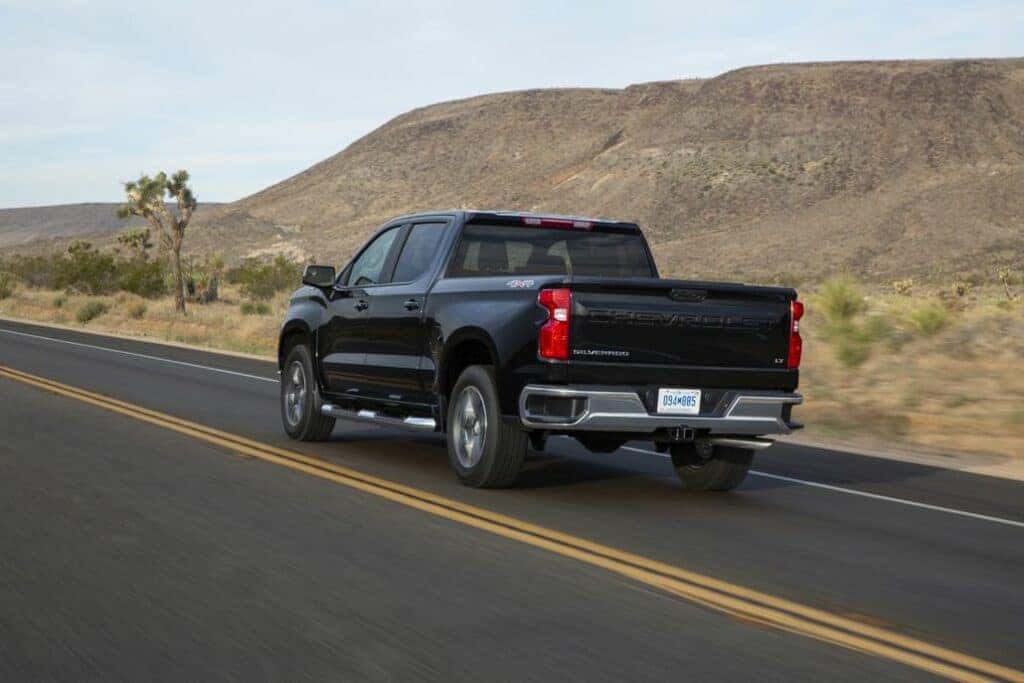 Chevrolet Silverado Driving Through a Desert Rear 3/4 View