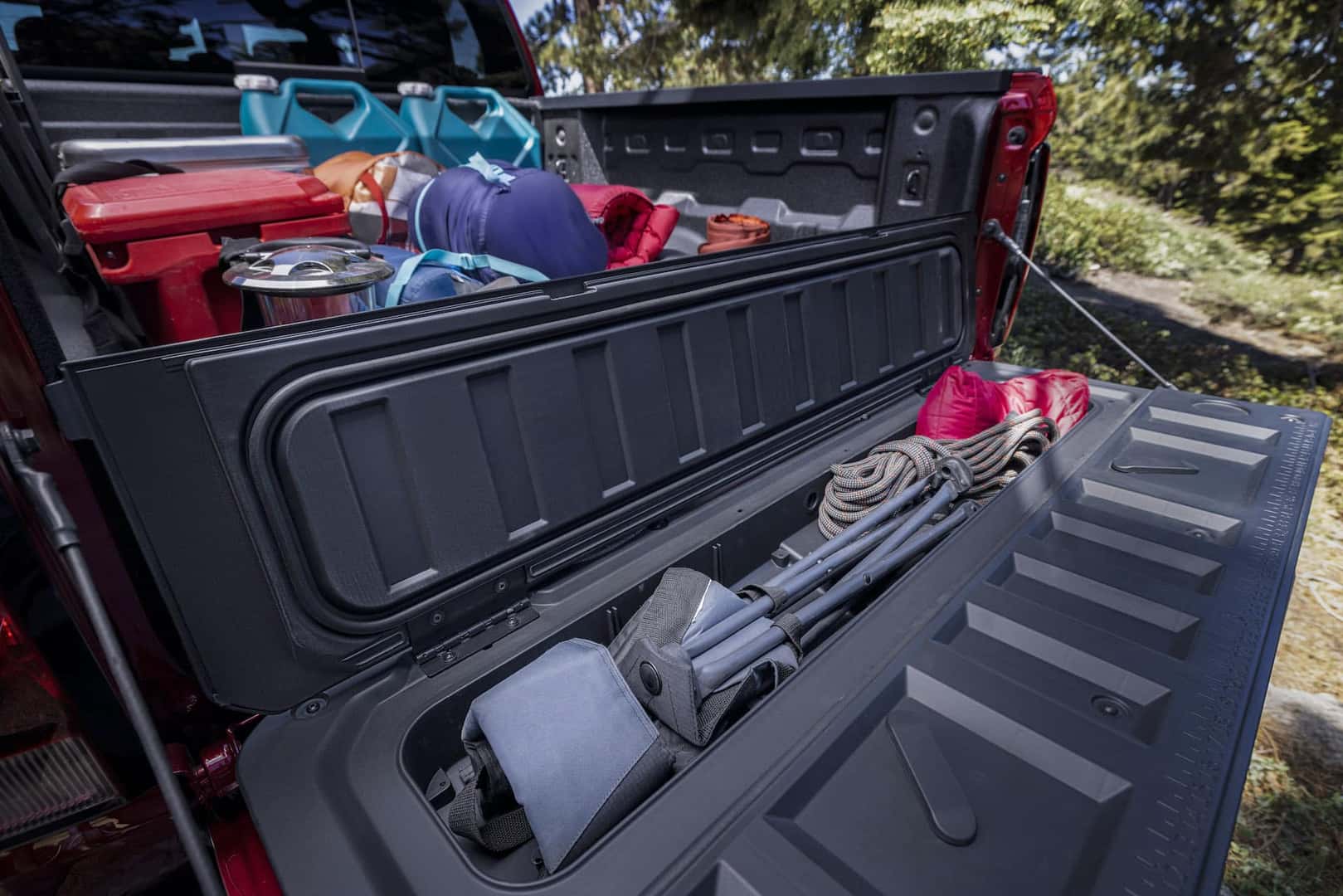 Lifestyle shot demonstrating how to optimize space in the truck bed's unique storage compartments with props.