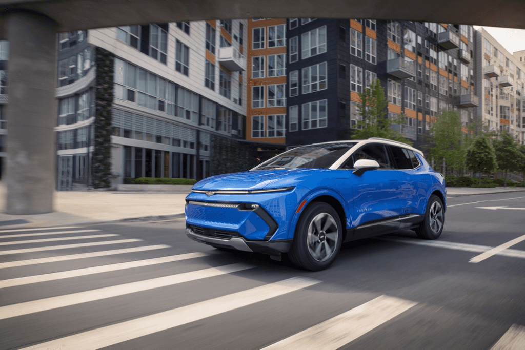 Chevrolet Equinox EV Driving in a City Front 3/4 View