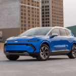 Riptide Blue Metallic 2025 Chevrolet Equinox EV LT parked in a city