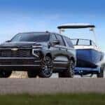 The Spacious 2025 Chevy Suburban, Hauling A Boat On Their Strong Trailer