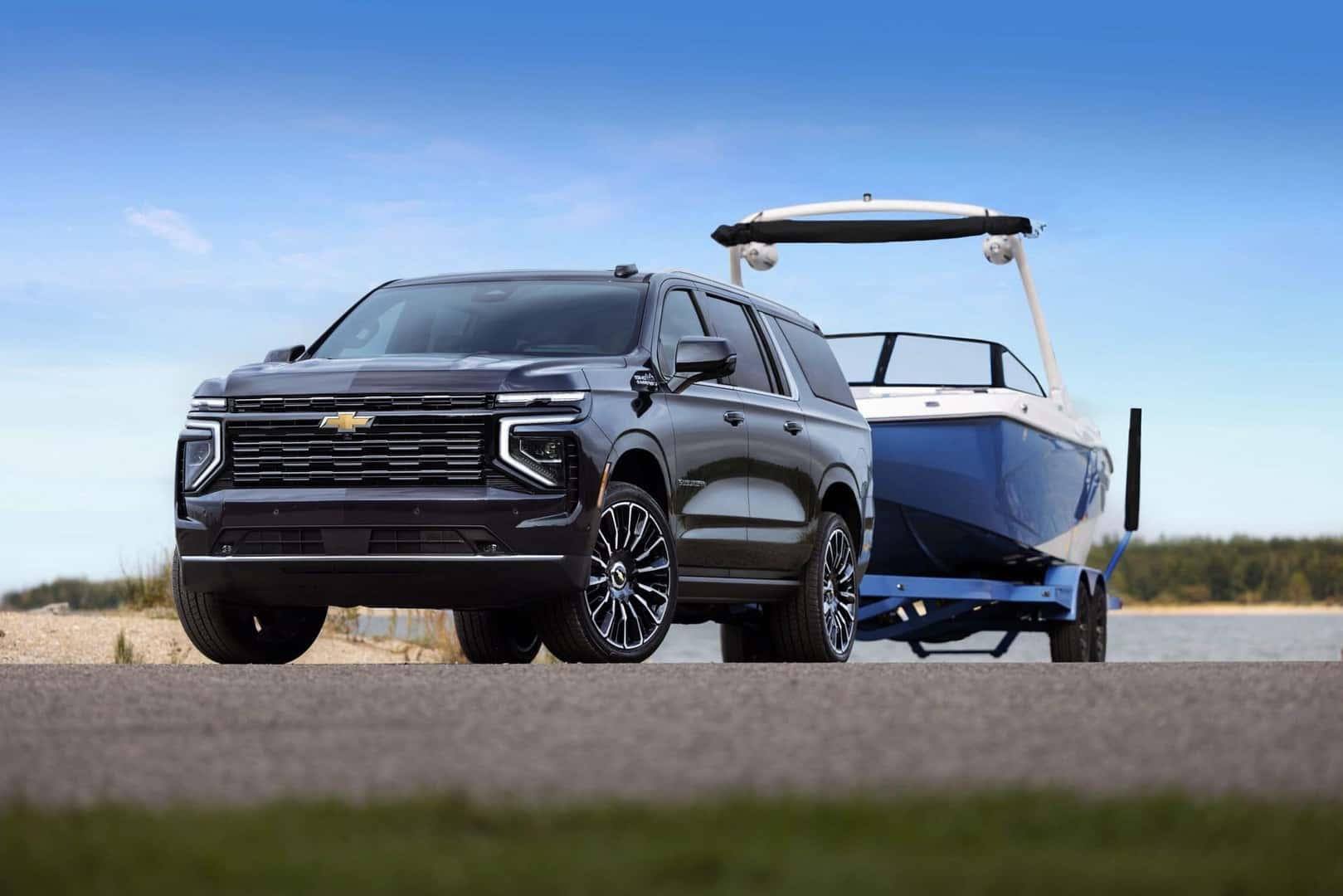 The Spacious 2025 Chevy Suburban, Hauling A Boat On Their Strong Trailer