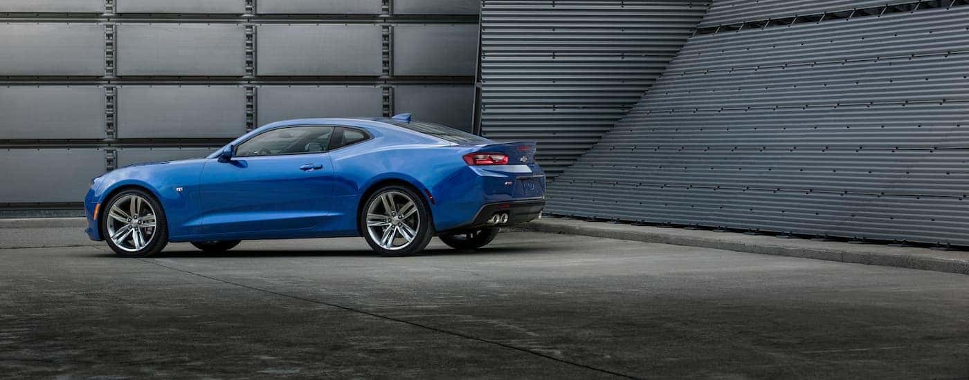 A blue 2016 Chevy Camaro RS is shown parked on concrete,