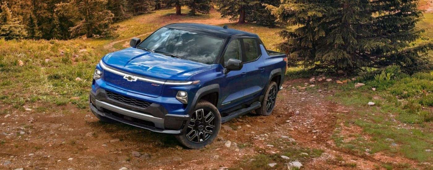 A blue 2024 Chevy Silverado EV RST is shown on a trail after leaving a Chevy dealer in Shreveport.