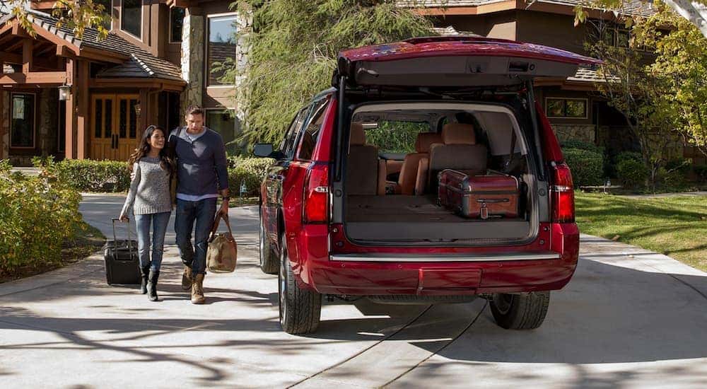 A red 2020 Chevy Tahoe is shown parked on a driveway.