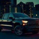 A black 2023 Chevy Silverado 1500 Custom is shown from the front at an angle.