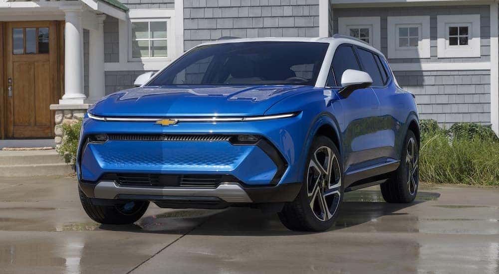 A blue 2024 Chevy Equinox EV is shown from the front at an angle after leaving a dealer that has a dealer that has a Chevy Equinox for sale.