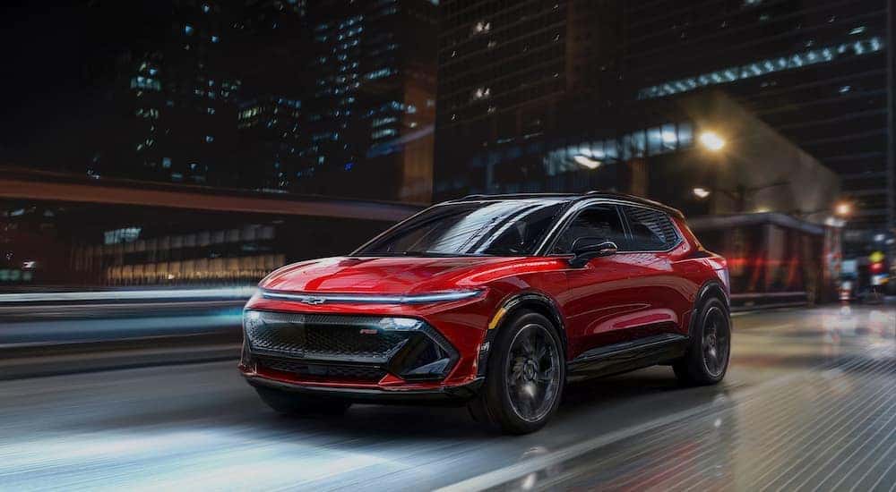 A red 2024 Chevy Equinox EV RS is shown from the front at an angle.