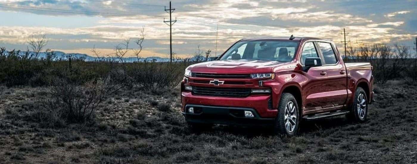 A popular Chevy Silverado for sale, a red 2023 Chevy Silverado 1500 RST is shown parked off-road.