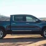 A popular Chevy Silverado for sale, a black 2024 Chevy Silverado 1500 High Country, is shown parked near a tree.