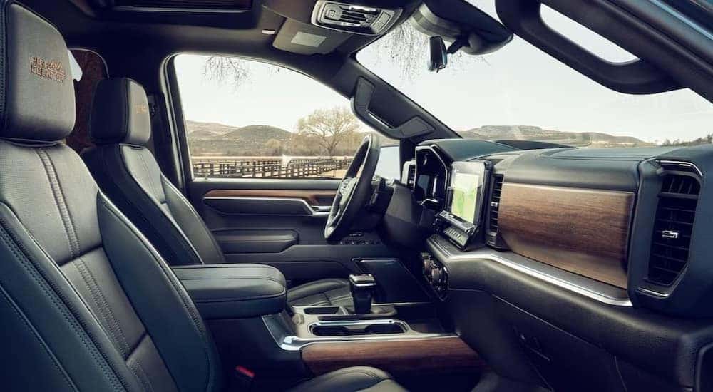 The black and brown interior and dash of a 2024 Chevy Silverado 1500 High Country is shown.
