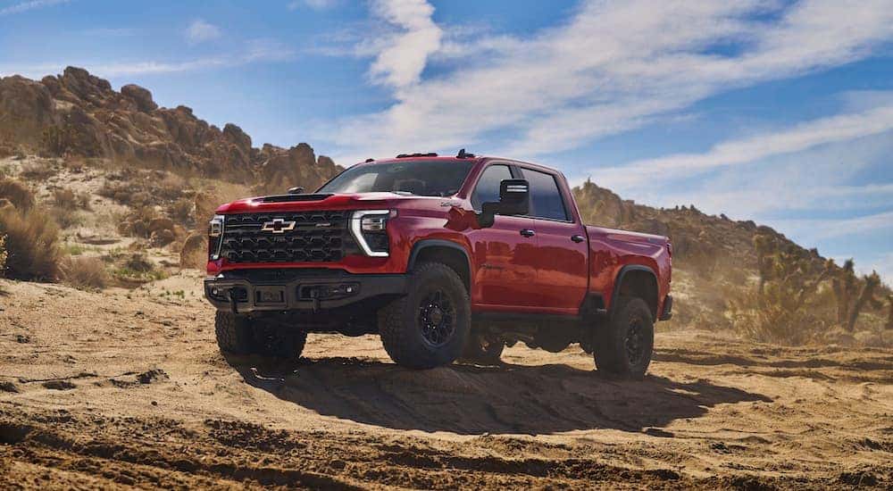 A red 2024 Chevy Silverado 2500 HD ZR2 is shown from the front at an angle.