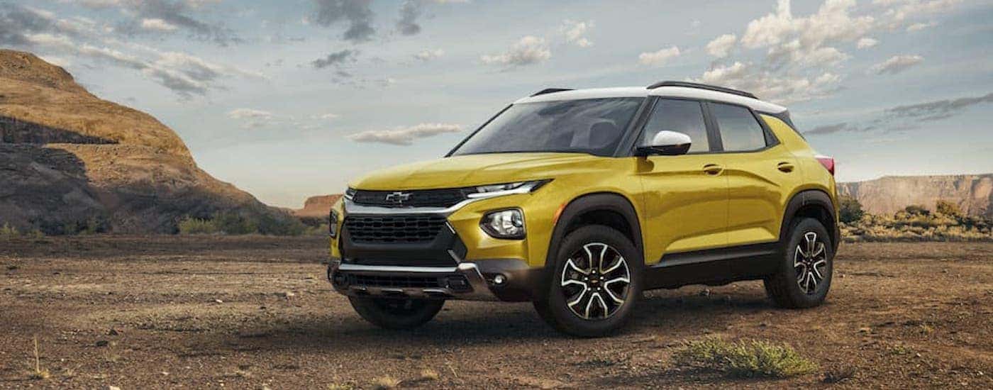 A yellow 2023 Chevy Trailblazer Activ is shown from the front at an angle after leaving a dealer that has a Chevy Trailblazer for sale.
