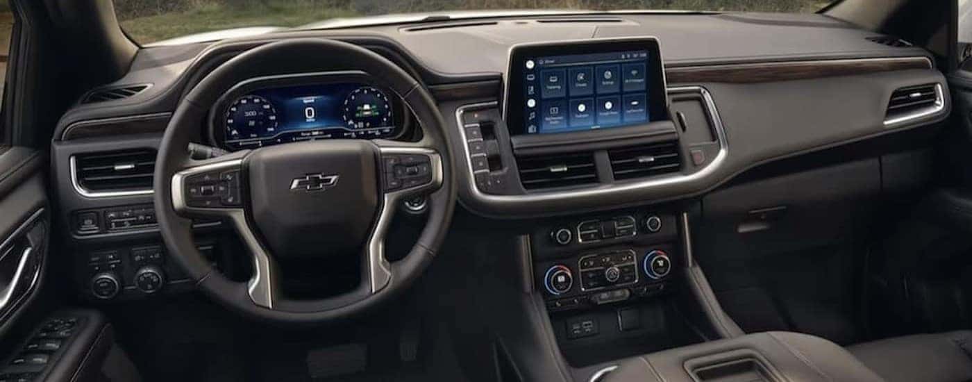 The gray interior and dash of a 2024 Chevy Tahoe is shown.