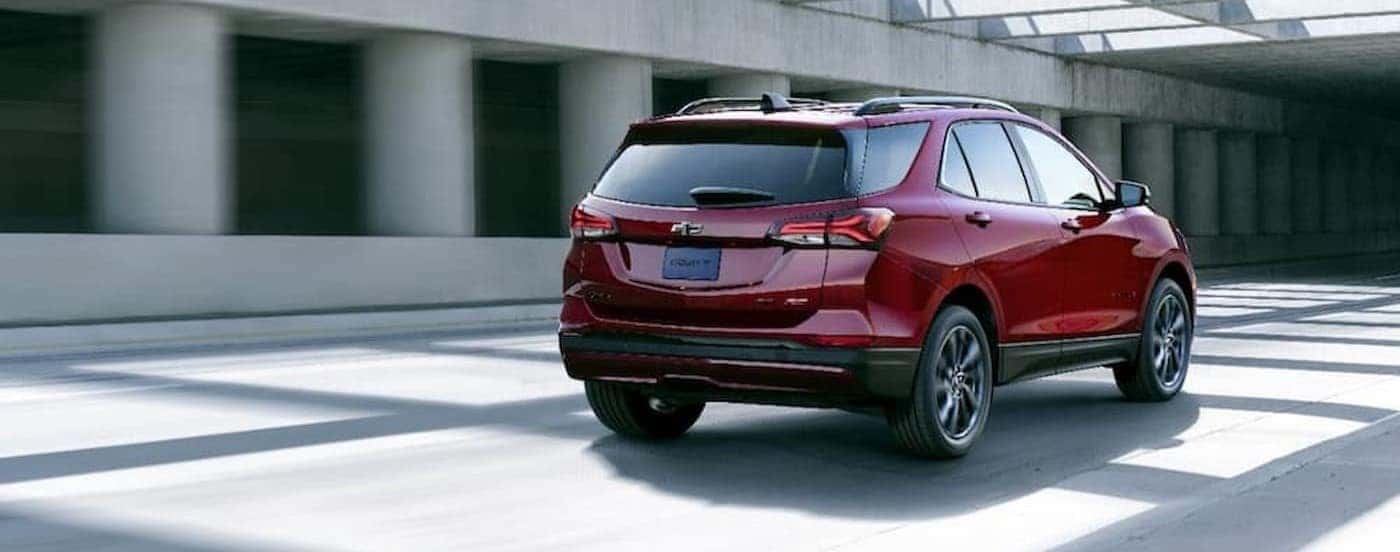 A red 2024 Chevy Equinox RS is shown driving in a tunnel.