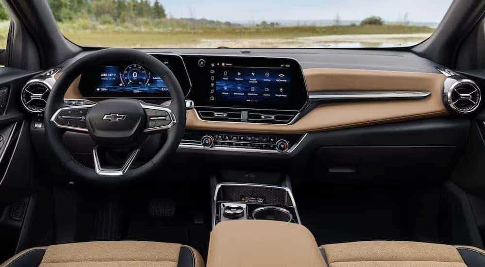 The black and brown interior and dash of a 2025 Chevy Equinox ACTIV is shown.