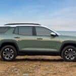 A green 2025 Chevy Equinox ACTIV is shown parked near water after visiting a Chevy dealer near Blanchard.