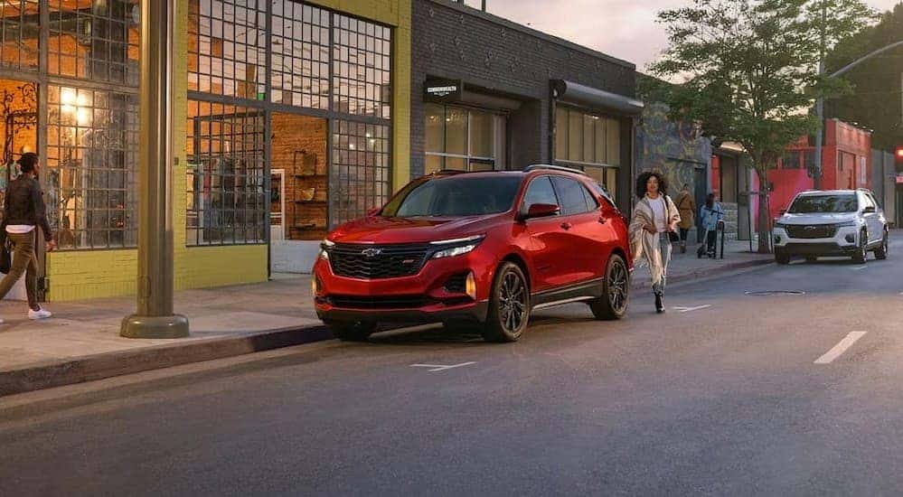 A red 2024 Chevy Equinox RS is shown parked after visiting a Chevy dealer near Benton.