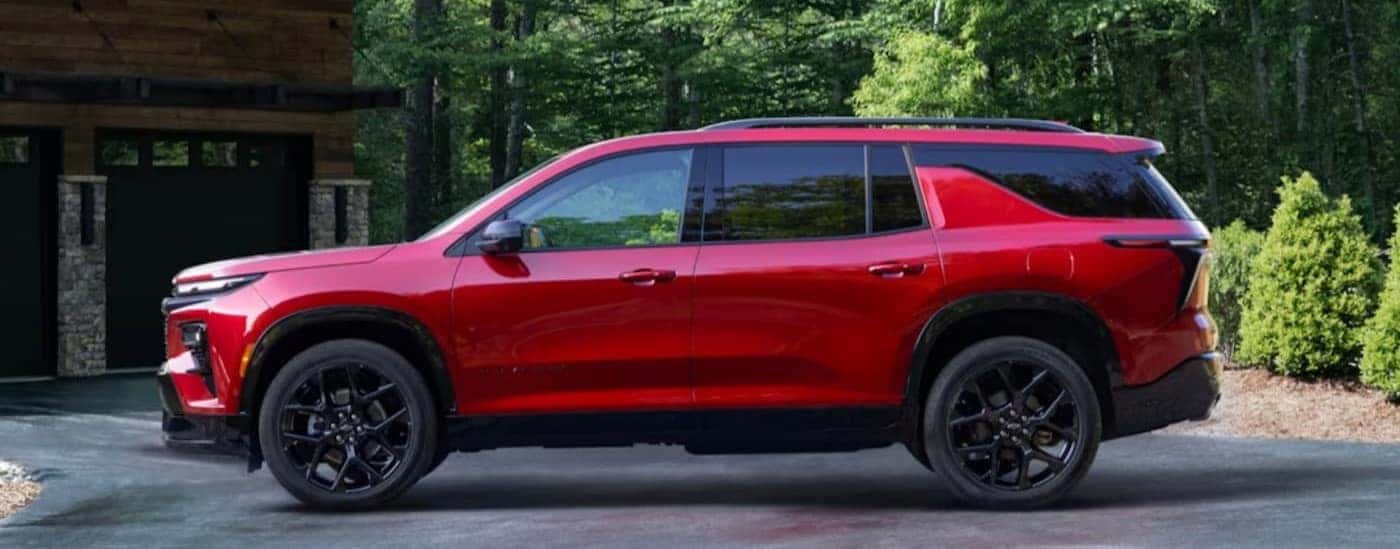 A red 2024 Chevy Traverse is shown parked on a driveway after visiting a Chevy dealer near Benton.