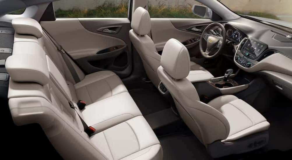 The white and gray interior and dash in a 2024 Chevy Malibu is shown.