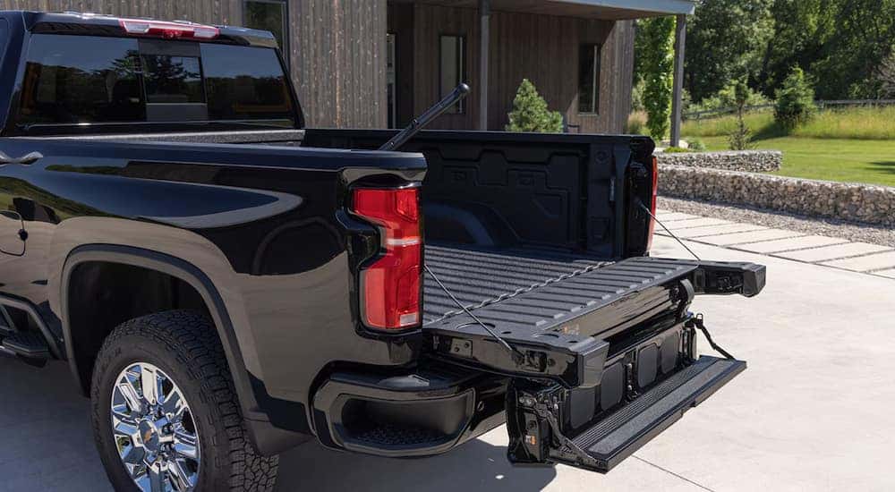 The open Multi-Flex tailgate on a black 2024 Chevy Silverado 2500 HD for sale near Bossier City.