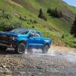 A blue 2024 Chevy Silverado 1500 ZR2 is shown from the front at an angle.