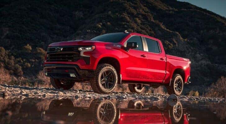A red 2023 Chevy Silverado 1500 Z71 Trail Boss is shown from the front at an angle.