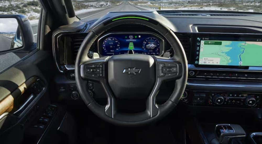 A close-up of the steering wheel and digital displays in a 2024 Chevy Silverado 1500 is shown after viewing a Chevy Silverado for sale in Shreveport.