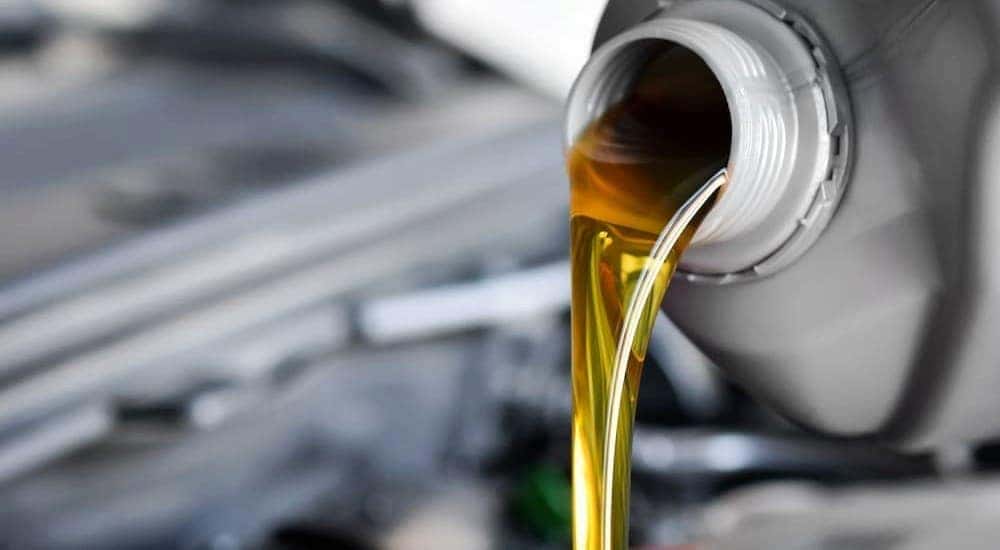 Oil is shown being poured from an oil container.