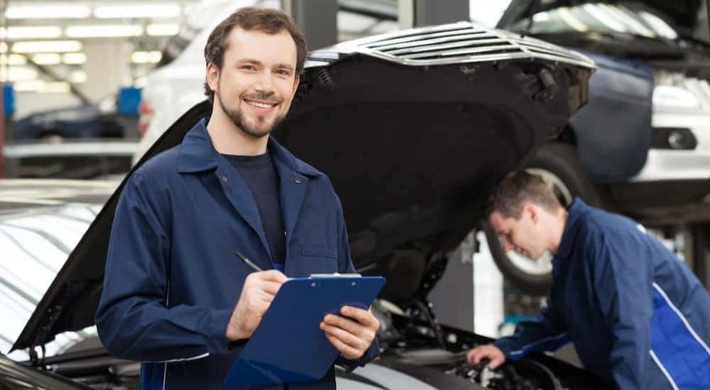 A mechanic is shown holding a clipboard after viewing a Chevy Silverado for sale in Shreveport.