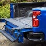 A blue 2024 Chevy Silverado 1500 ZR2 is shown from the rear at an angle.