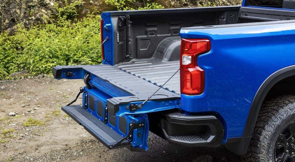 A blue 2024 Chevy Silverado 1500 ZR2 is shown from the rear at an angle.