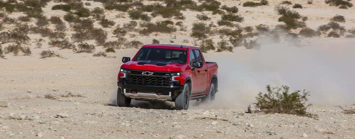 A red 2024 Chevy Silverado 1500 ZR2 is shown from the front at an angle after leaving a Chevy dealer near Carthage.