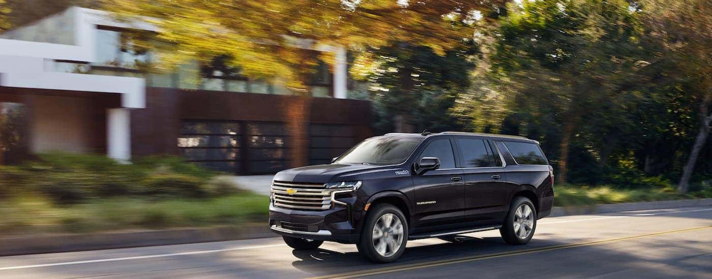 A grey 2022 Chevy Suburban is shown from the side.