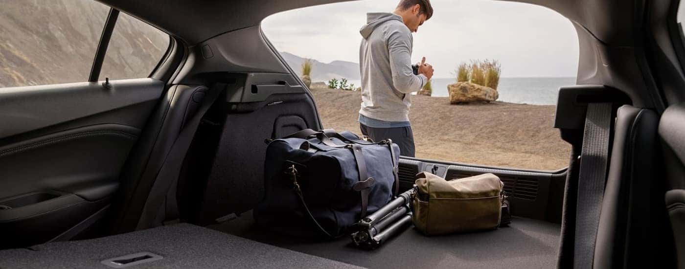 A person with a camera is shown near a 2019 Chevy Cruze.