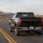 A black 2025 Chevy Silverado 1500 LT from the rear.