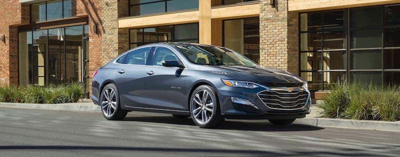 A grey 2019 Chevy Malibu parked on a street.