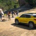 A yellow 2026 Chevy Trailblazer ACTIV parked near a tent.