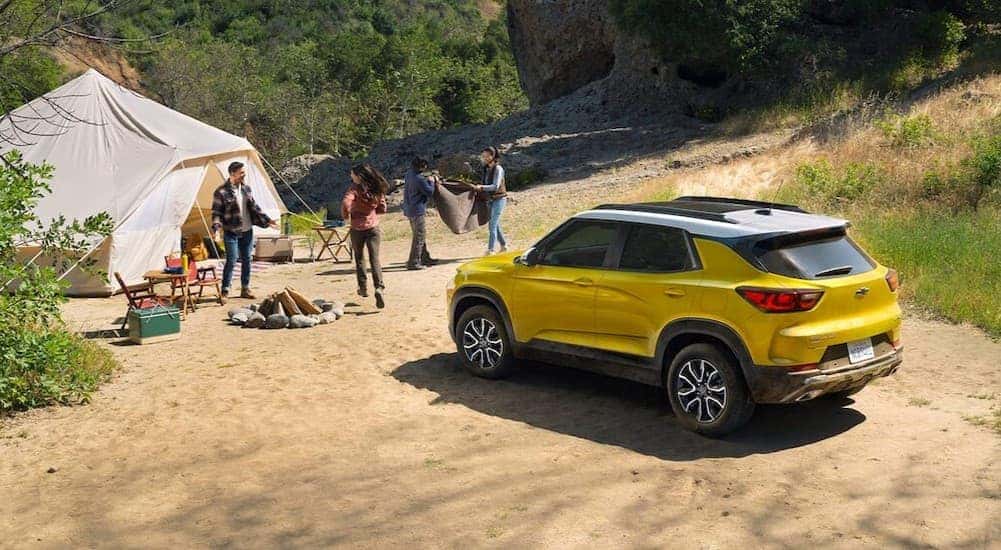 A yellow 2026 Chevy Trailblazer ACTIV parked near a tent.