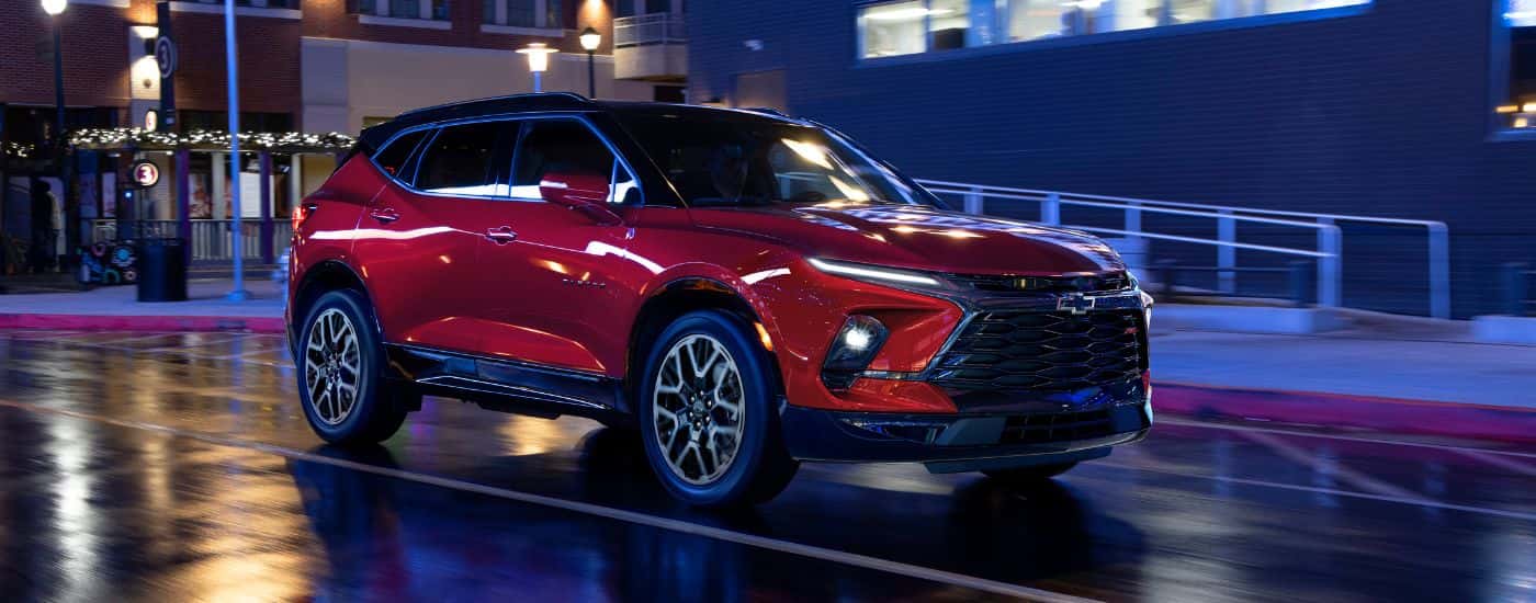 A red 2023 Chevy Blazer RS driving at night.