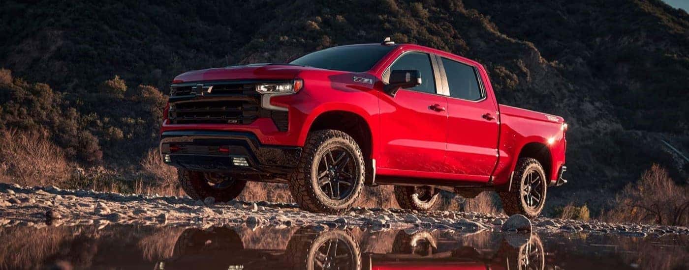 A red 2023 Chevy Silverado 1500 Z71 Trail Boss is shown from the front at an angle.